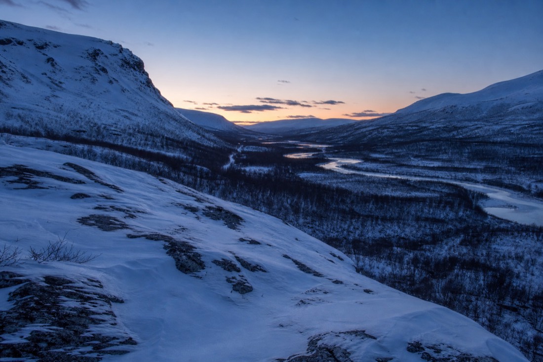 Blue hour over a Lapland valley, snow holding the last light